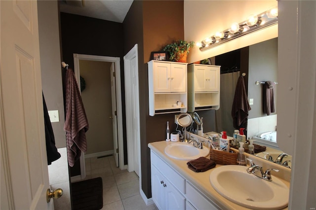 bathroom with tile patterned flooring and vanity