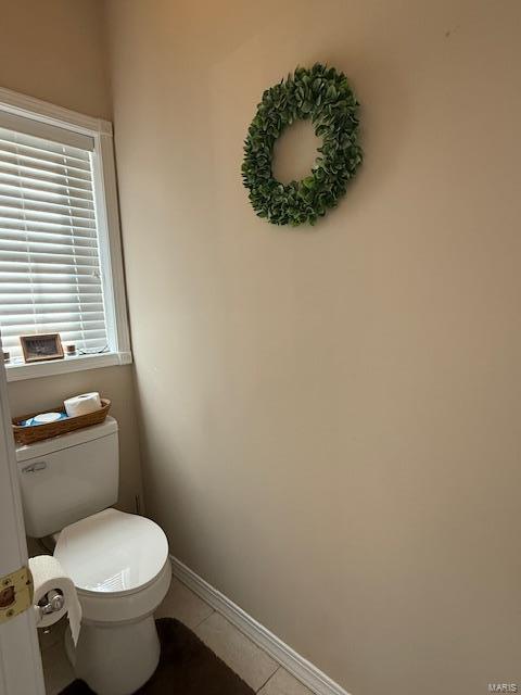 bathroom with tile patterned flooring and toilet