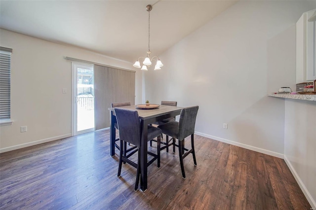 dining area with dark hardwood / wood-style floors, a chandelier, and vaulted ceiling