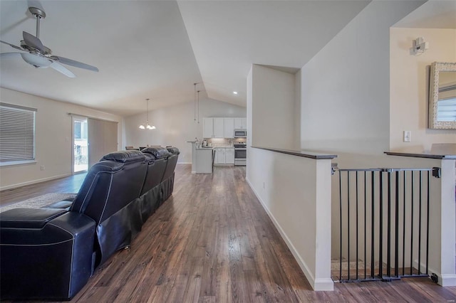 living room with lofted ceiling, dark hardwood / wood-style floors, and ceiling fan with notable chandelier