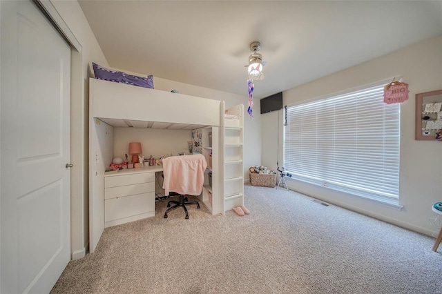 bedroom with multiple windows, light colored carpet, and ceiling fan