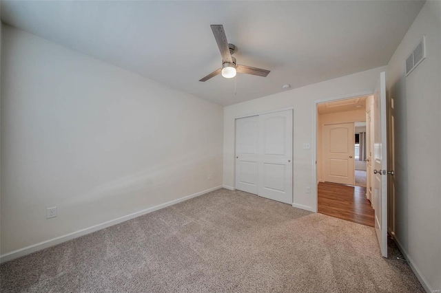 unfurnished bedroom featuring ceiling fan, carpet flooring, and a closet