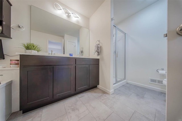 bathroom featuring vanity and a shower with shower door