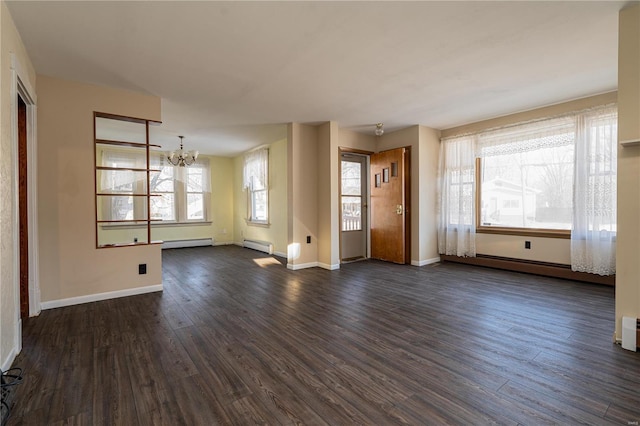 unfurnished living room featuring dark hardwood / wood-style flooring, a baseboard radiator, and an inviting chandelier