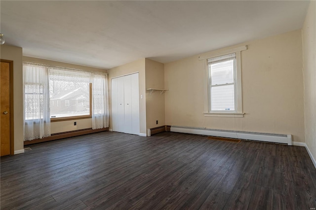 unfurnished bedroom featuring a baseboard radiator and dark wood-type flooring