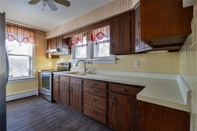 kitchen featuring stainless steel electric stove, sink, backsplash, dark hardwood / wood-style flooring, and baseboard heating