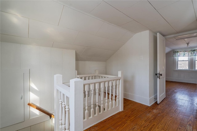 hall featuring vaulted ceiling and wood-type flooring