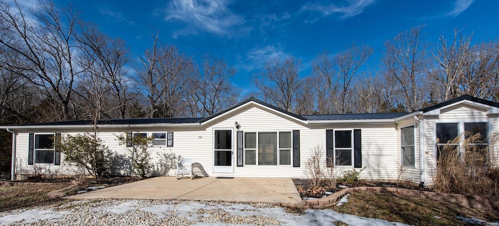 snow covered property featuring a patio