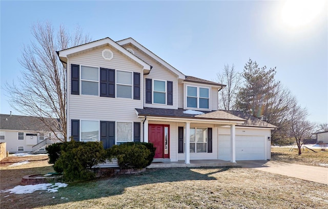 view of front of property with a garage, a front yard, and covered porch