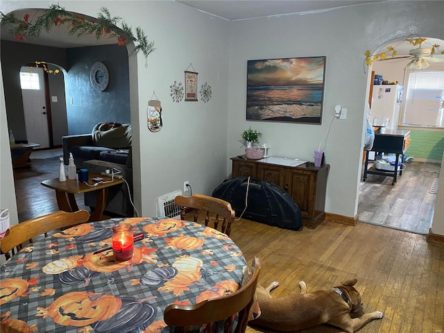 dining space with wood-type flooring