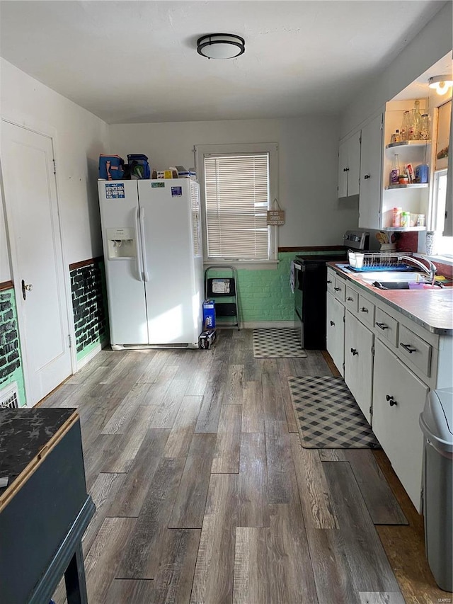 kitchen with white cabinetry, range with electric stovetop, sink, and white fridge with ice dispenser