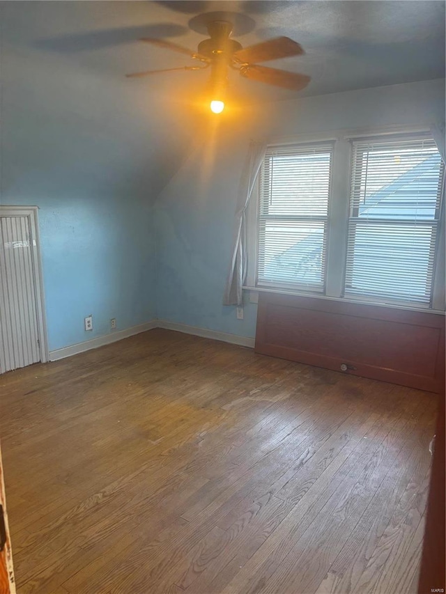 additional living space featuring lofted ceiling, hardwood / wood-style floors, and ceiling fan