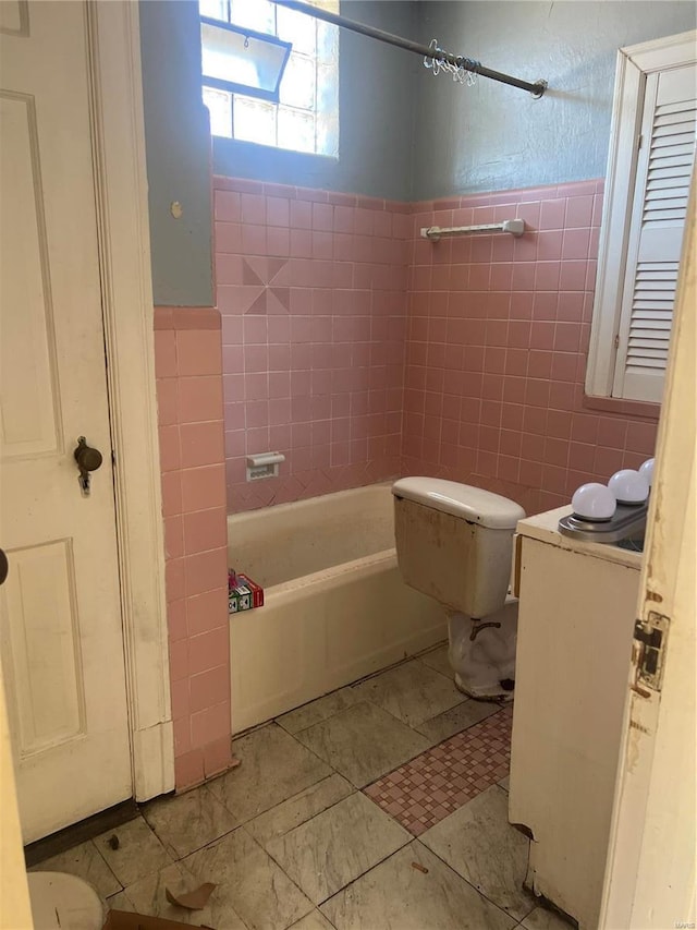 bathroom featuring bathtub / shower combination, tile walls, and toilet