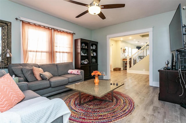 living room with ceiling fan and hardwood / wood-style floors