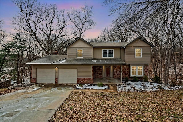 view of front of property with brick siding, driveway, and an attached garage