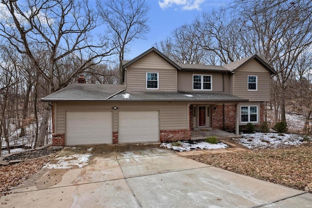 view of front facade featuring brick siding, a chimney, a porch, a garage, and driveway