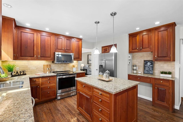 kitchen featuring light stone countertops, appliances with stainless steel finishes, dark wood-type flooring, and a sink