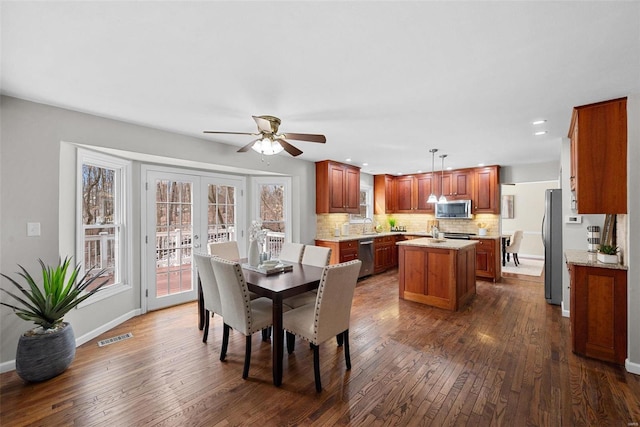 dining room featuring baseboards, visible vents, dark wood-style floors, french doors, and recessed lighting