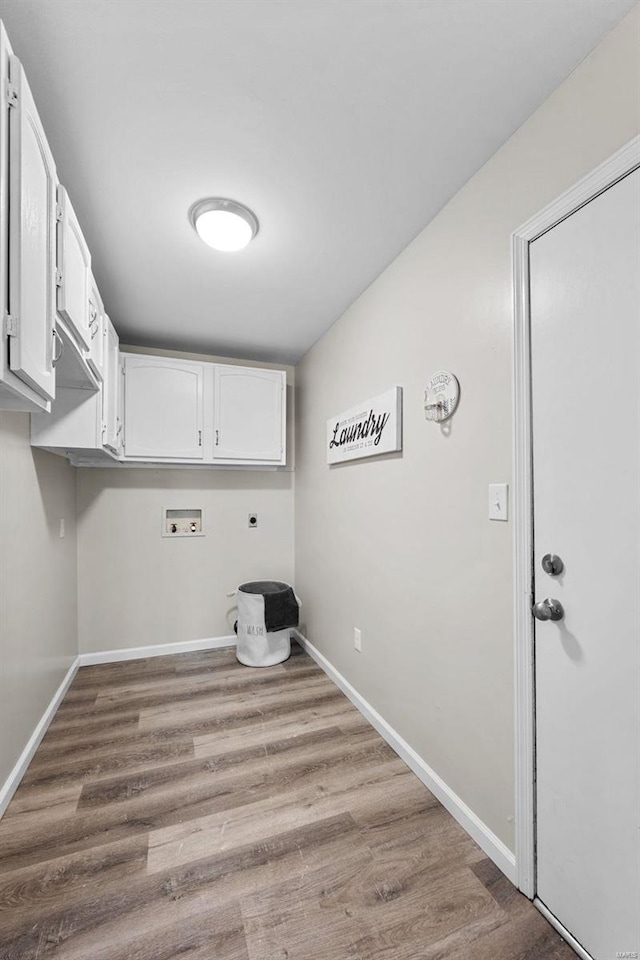 laundry area featuring washer hookup, cabinet space, electric dryer hookup, and wood finished floors