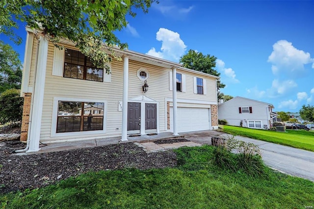 view of front facade with a front yard and a garage