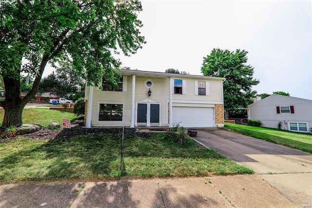 bi-level home with a garage and a front lawn