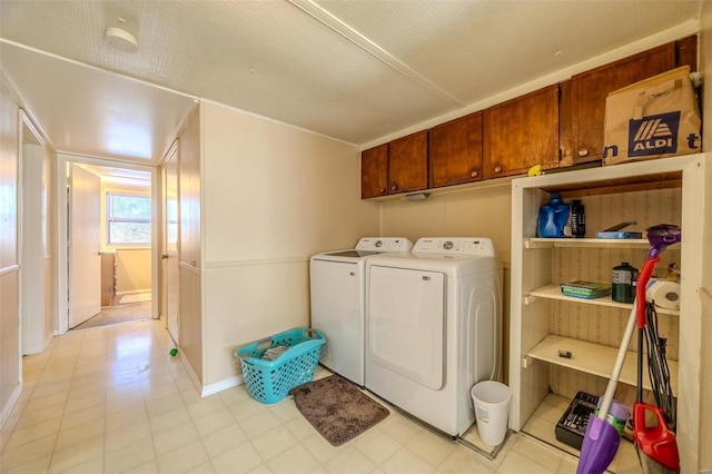 laundry room with washer and dryer and cabinets