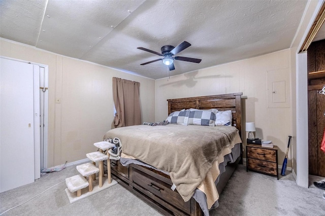 bedroom with ceiling fan, carpet flooring, and a textured ceiling