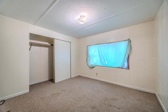 unfurnished bedroom with carpet floors and a closet