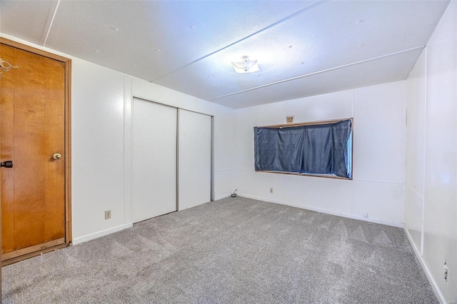 unfurnished bedroom featuring a closet and carpet floors