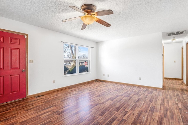 unfurnished room with dark hardwood / wood-style flooring, a textured ceiling, and ceiling fan