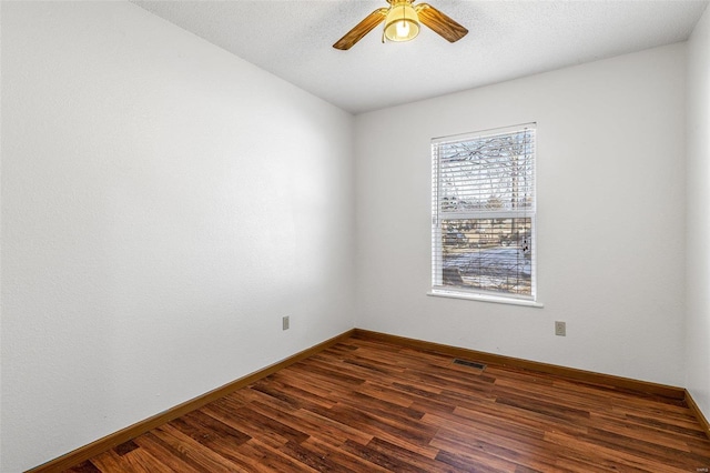 spare room featuring dark hardwood / wood-style floors and ceiling fan