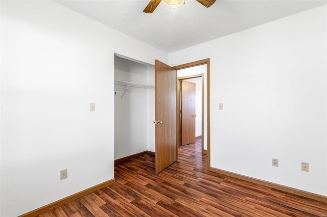 unfurnished bedroom featuring ceiling fan, dark hardwood / wood-style floors, a closet, and a textured ceiling