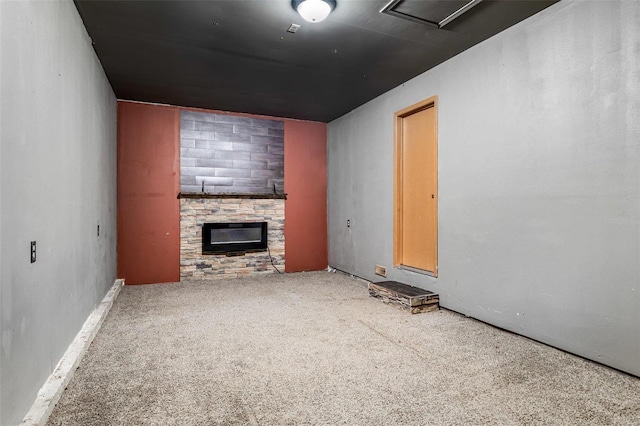 unfurnished living room with carpet flooring and a fireplace