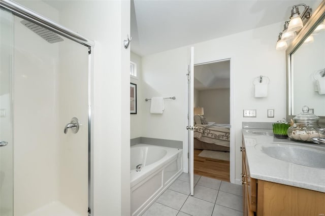 bathroom with tile patterned flooring, vanity, and independent shower and bath