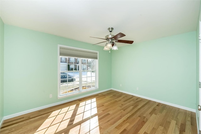 empty room with ceiling fan and light hardwood / wood-style floors