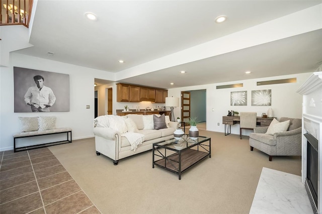 living room with a premium fireplace and carpet