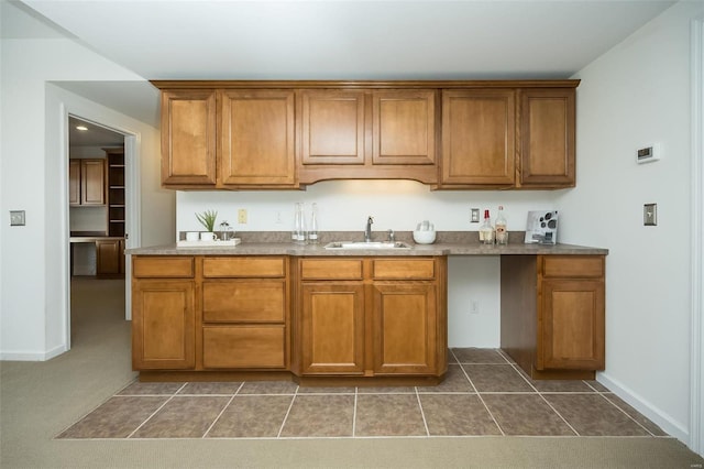 kitchen featuring sink and dark carpet