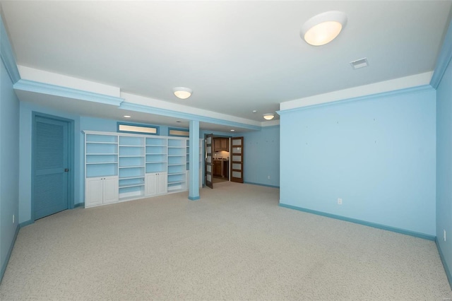 unfurnished room featuring built in shelves and carpet floors