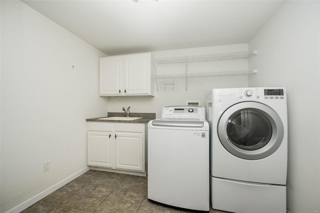 laundry area featuring cabinets, sink, and independent washer and dryer