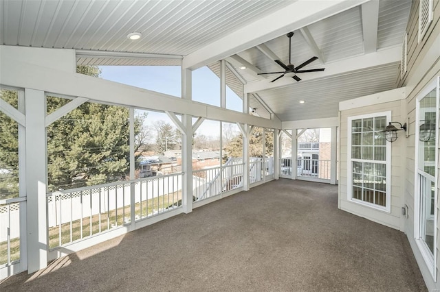 unfurnished sunroom with lofted ceiling with beams, plenty of natural light, and ceiling fan