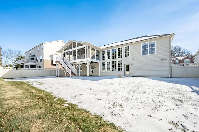 rear view of property with a sunroom