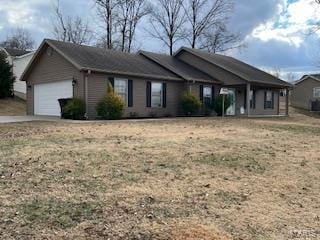 view of front of home with a garage and a front lawn