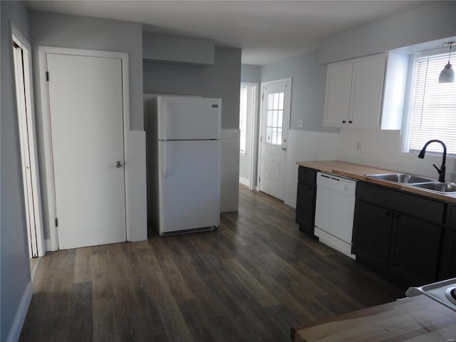 kitchen featuring sink, white appliances, white cabinets, and plenty of natural light