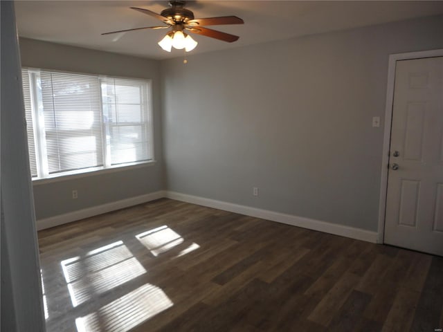 spare room featuring ceiling fan and dark wood-type flooring