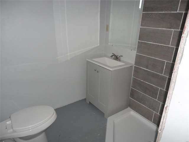 bathroom featuring a shower, toilet, vanity, and concrete floors