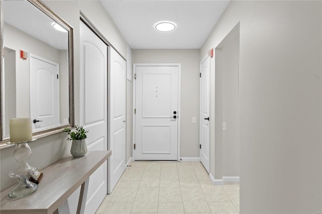 entryway with light tile patterned flooring