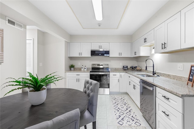 kitchen featuring white cabinetry, sink, stainless steel appliances, and light stone countertops