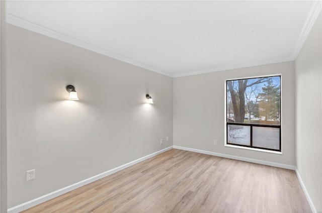 empty room featuring ornamental molding and light hardwood / wood-style floors