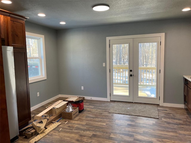 doorway to outside with dark hardwood / wood-style flooring and french doors