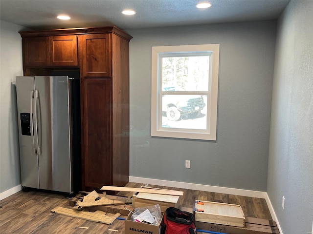 kitchen featuring dark hardwood / wood-style flooring and stainless steel fridge with ice dispenser